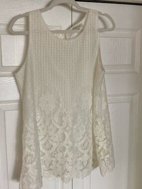 Sleeveless white blouse with floral lace overlay